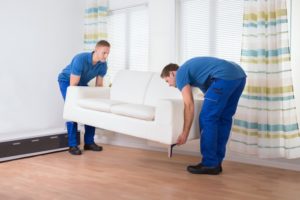 Movers Placing Sofa On Floor At Home 1
